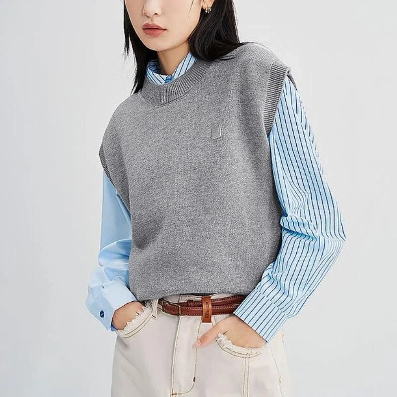 A cozy and chic knitted sleeveless vest in various colours, featuring a straight silhouette and a blend of premium materials for warmth and comfort.