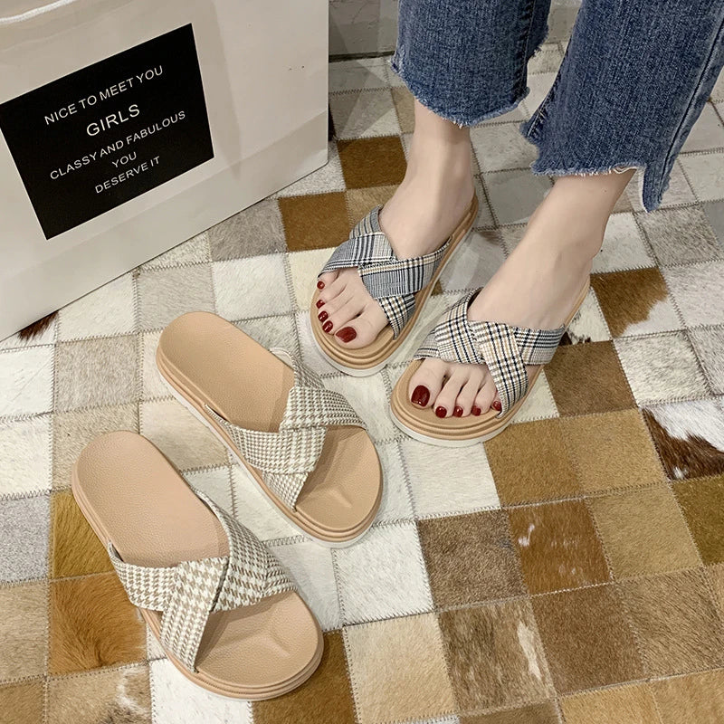 Comfortable and stylish herringbone slippers with a charming bow detail, perfect for indoor and light outdoor use.