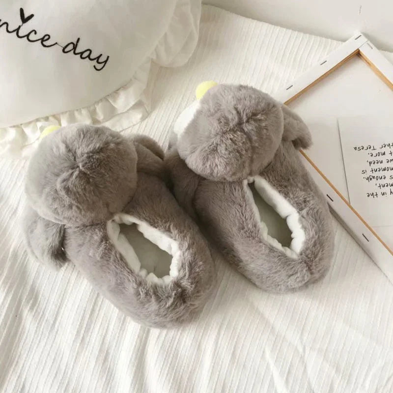 Pair of cosy, plush home slippers featuring a playful penguin design