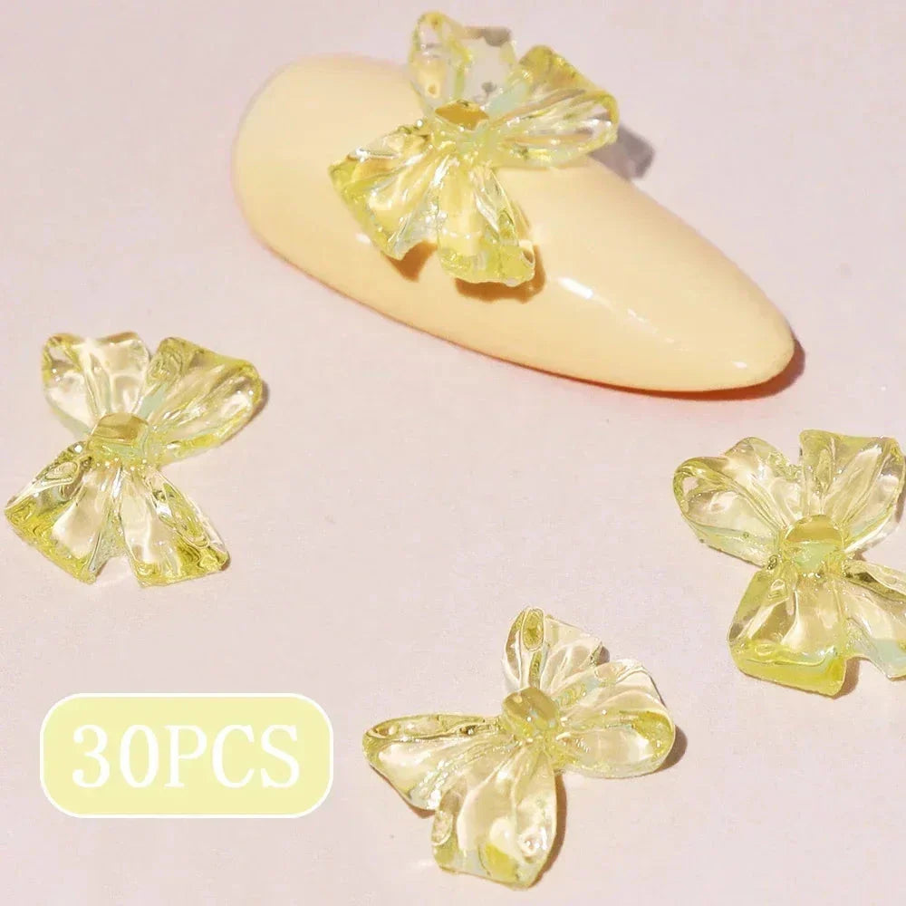 Charming candy-coloured bow nail charms in various colours, perfect for adding a playful touch to your manicure