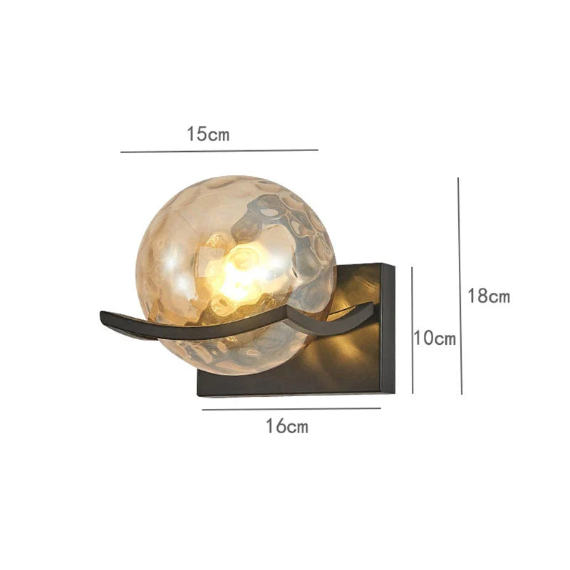 Modern black iron wall lamp with clear glass shade and LED lighting for a sophisticated look