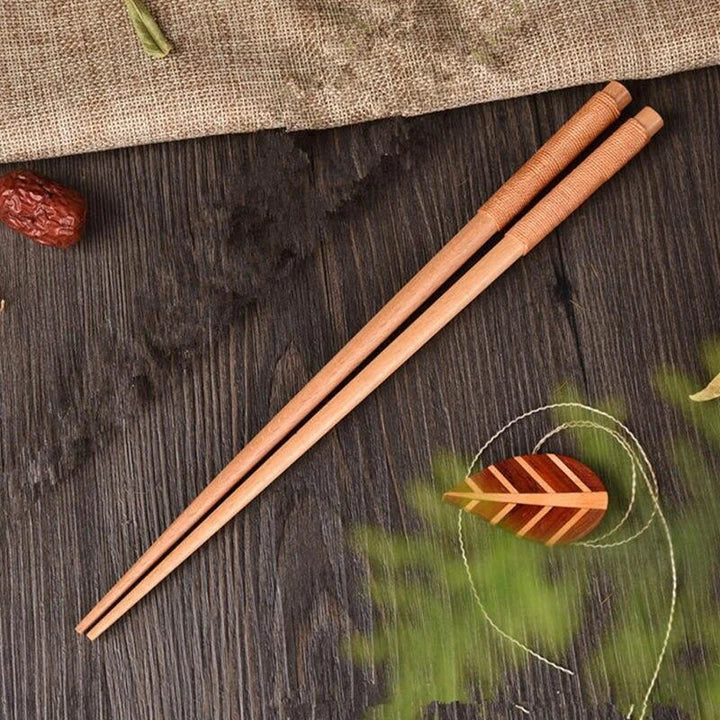 Pair of natural chestnut wood chopsticks with a rustic, earthy tone and elegant design