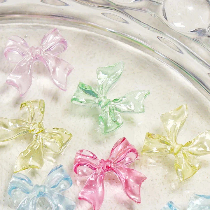 Charming candy-coloured bow nail charms in various colours, perfect for adding a playful touch to your manicure