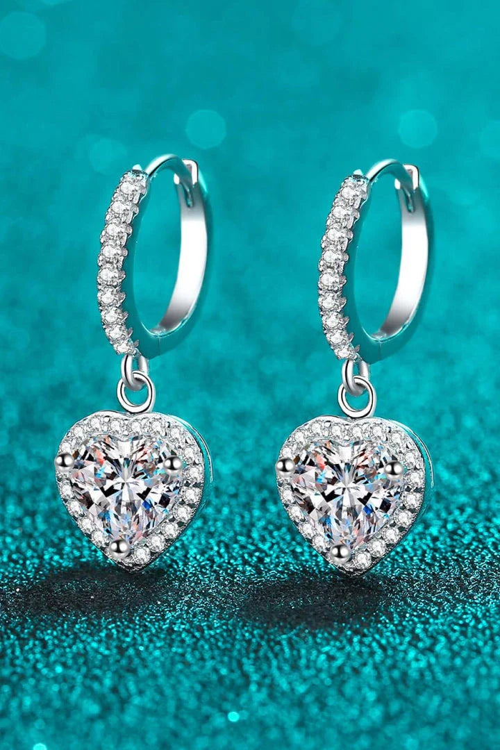 A pair of elegant moissanite heart-shaped drop earrings with a brilliant 2-carat display, crafted in 925 sterling silver with rhodium plating and zircon accents.