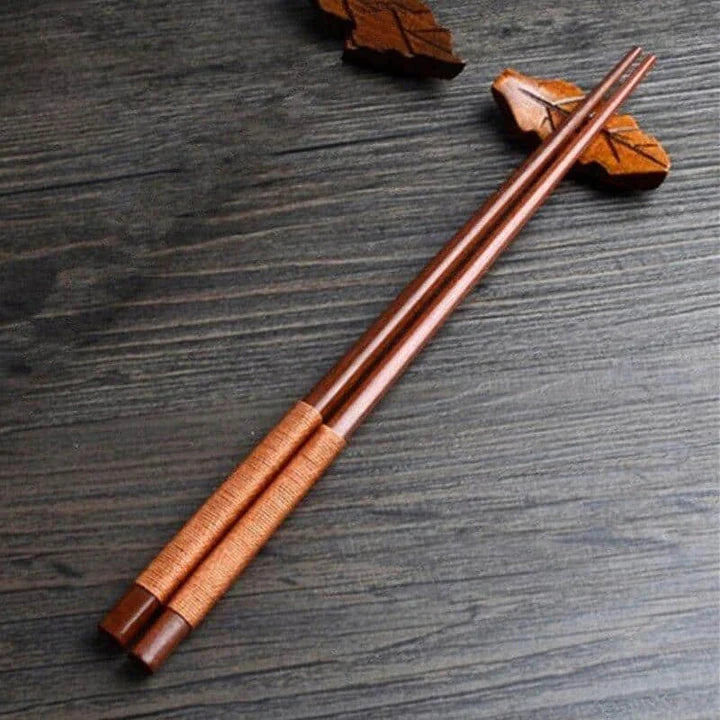 Pair of natural chestnut wood chopsticks with a rustic, earthy tone and elegant design