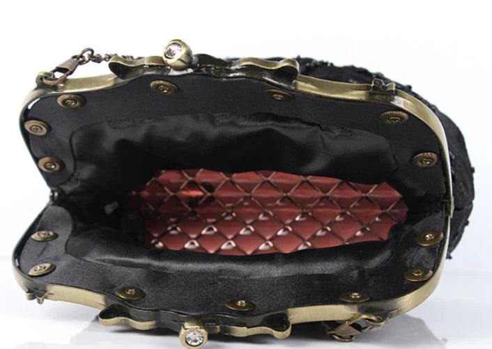 A black cosmetic bag with exquisite bead embroidery, featuring a silk surface and nylon fabric texture for a luxurious feel.