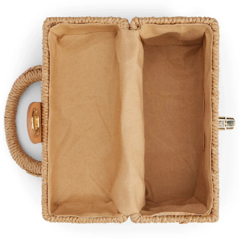 Handcrafted natural straw beach bag with bohemian-inspired design and detachable metal chain strap
