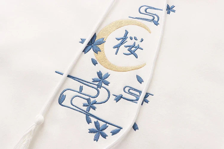 A cosy, velvet-padded hooded sweater with playful alphabet sleeves in pink and blue colours