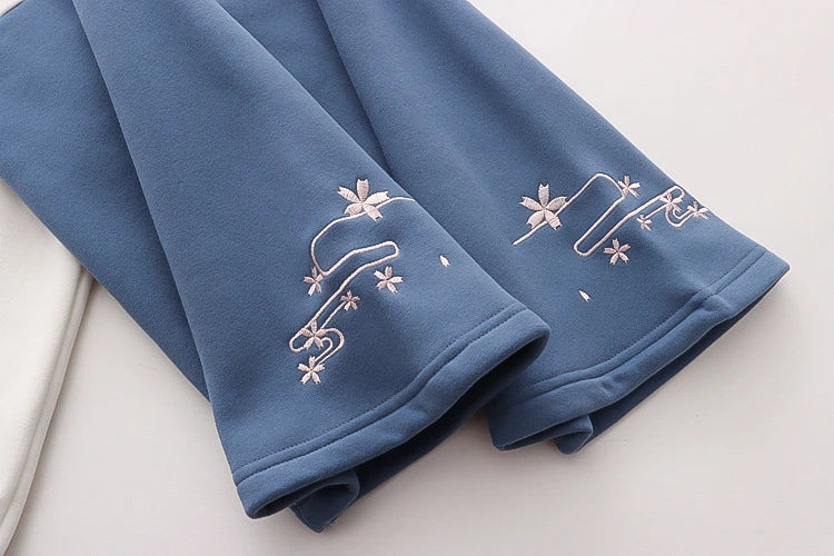 A cosy, velvet-padded hooded sweater with playful alphabet sleeves in pink and blue colours