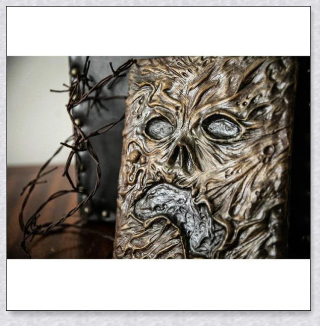 A haunting Necronomicon book with an embossed monster cover, aged pages, and a leathery, deathly texture