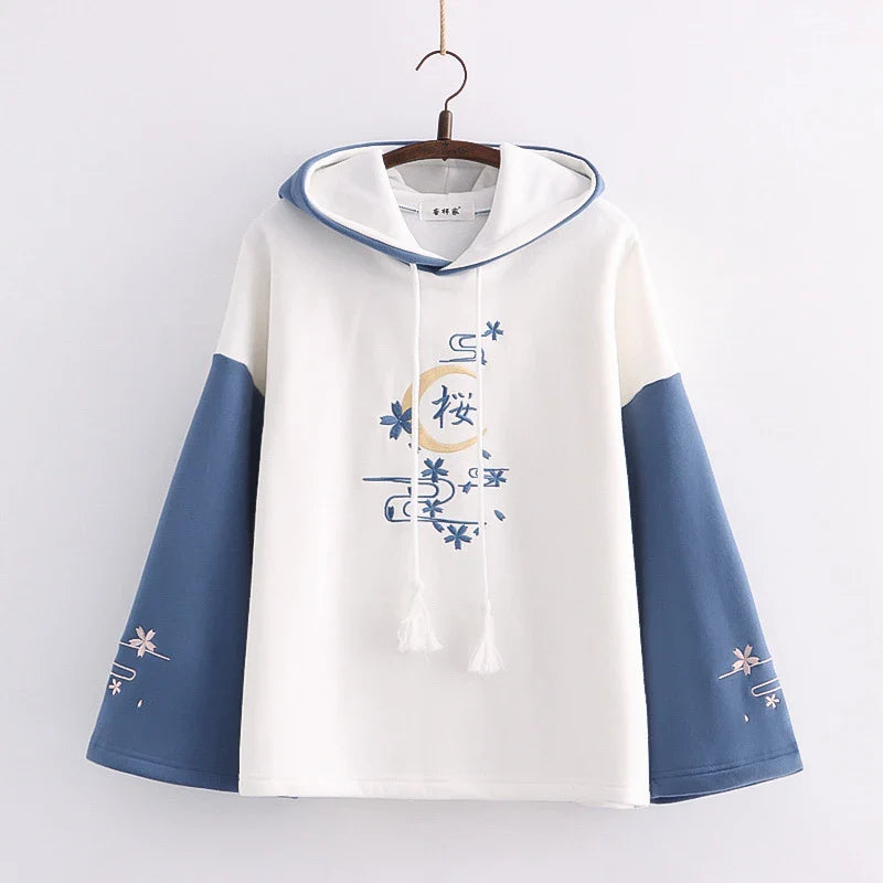 A cosy, velvet-padded hooded sweater with playful alphabet sleeves in pink and blue colours