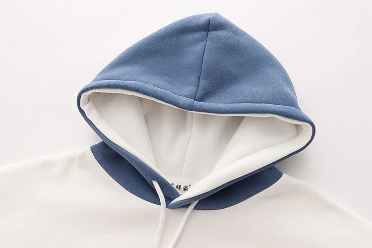 A cosy, velvet-padded hooded sweater with playful alphabet sleeves in pink and blue colours