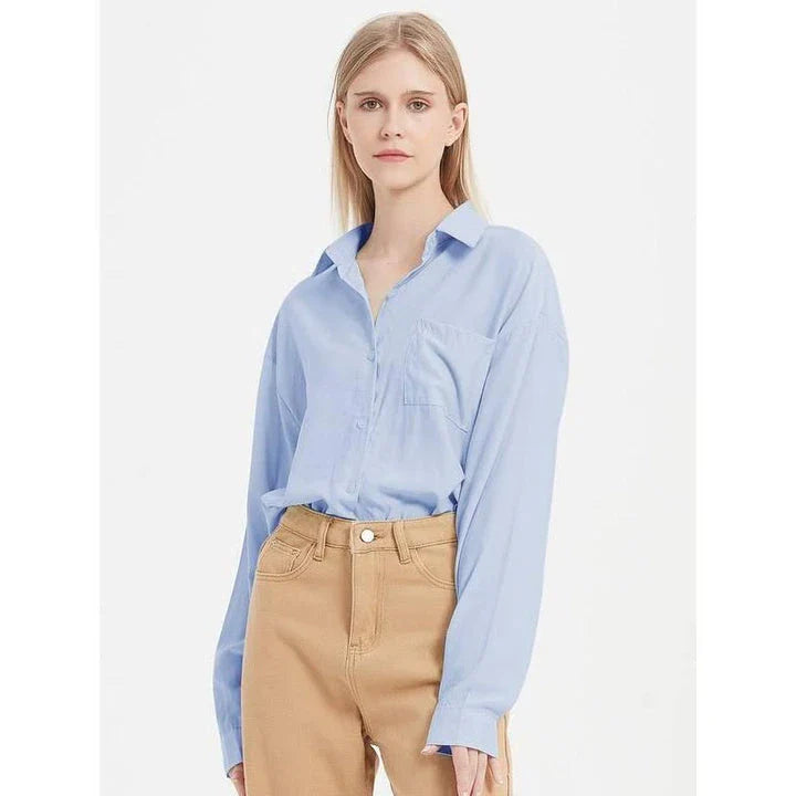 A classic long-sleeve button-up blouse in a range of chic colours, offering timeless elegance and modern sophistication for the fashion-conscious woman.