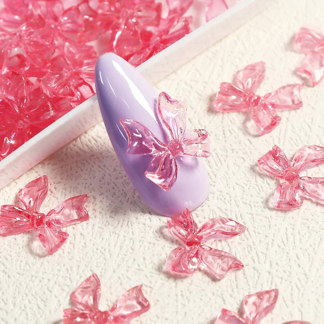 Charming candy-coloured bow nail charms in various colours, perfect for adding a playful touch to your manicure