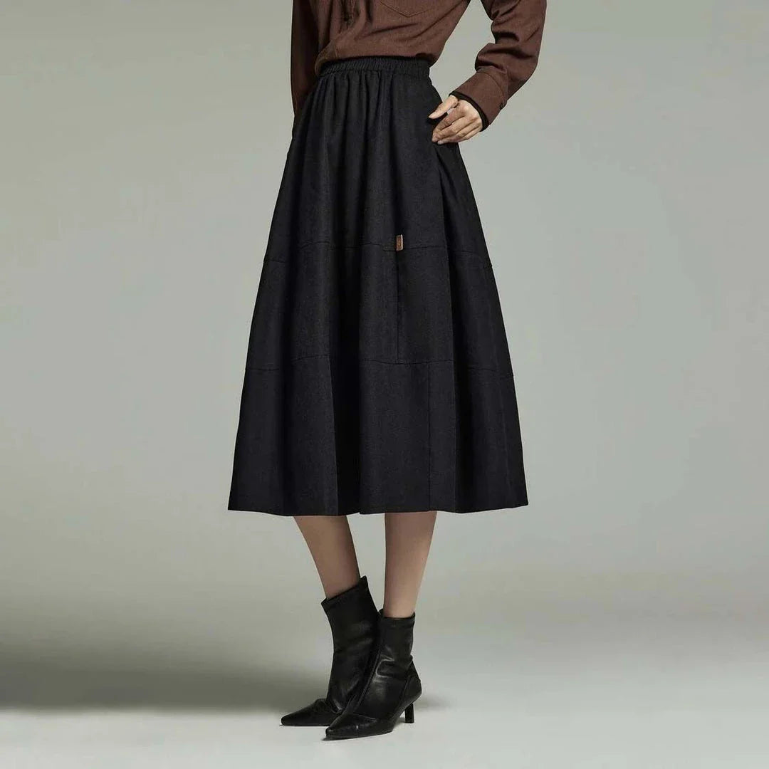 A stylish and sophisticated mid-length A-line pleated skirt with pockets, crafted from high-quality twill fabric for durability and comfort.