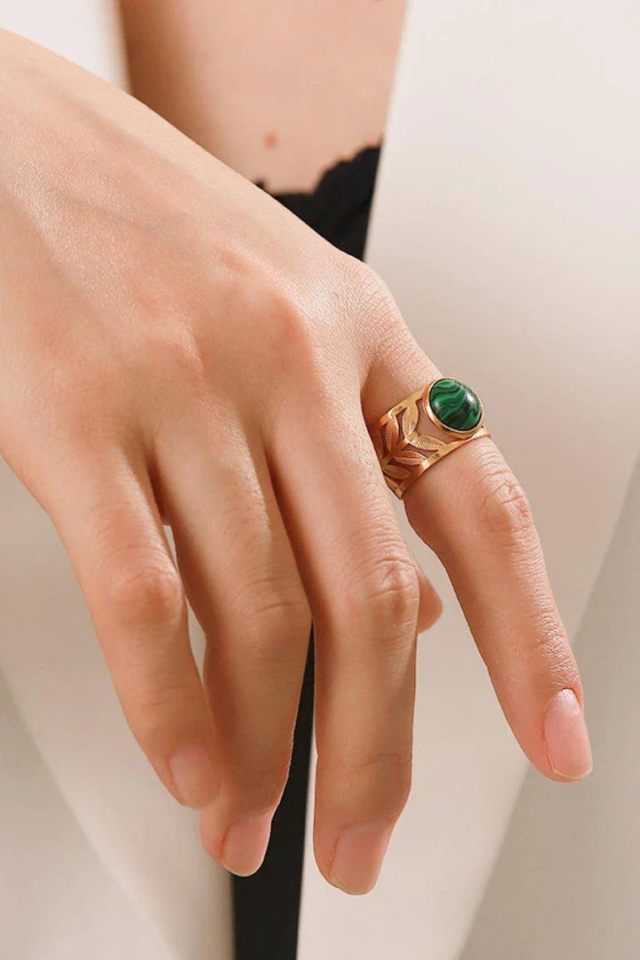 Elegant 18K gold-plated malachite leaf ring in a flat lay, studio style photograph