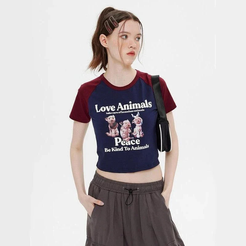 Enchanting animal print crop top with raglan sleeves and distressed details, perfect for casual summer outfits.