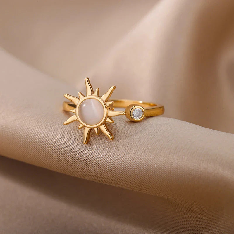 Adjustable stainless steel ring with rotating sun opal centerpiece, offering a modern and sophisticated geometric design for fashionable women
