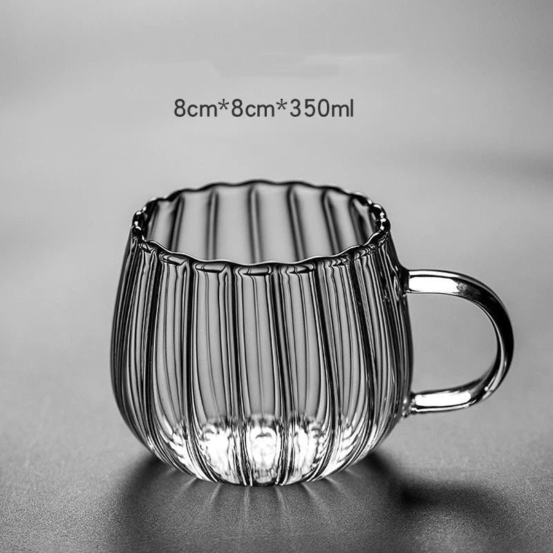 A set of heat-resistant glass mugs featuring a charming pumpkin pattern design, perfect for cosy UK mornings.