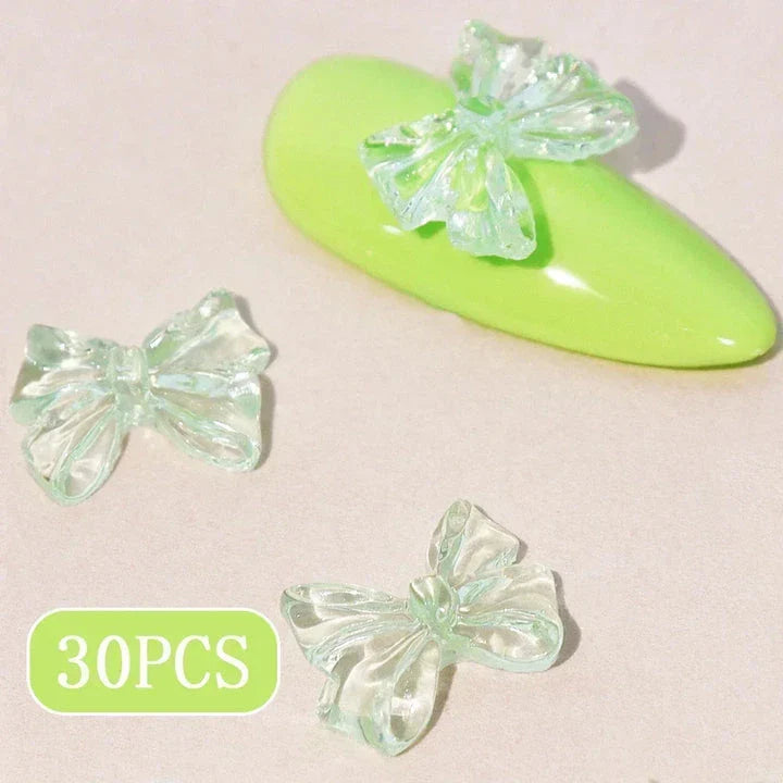 Charming candy-coloured bow nail charms in various colours, perfect for adding a playful touch to your manicure