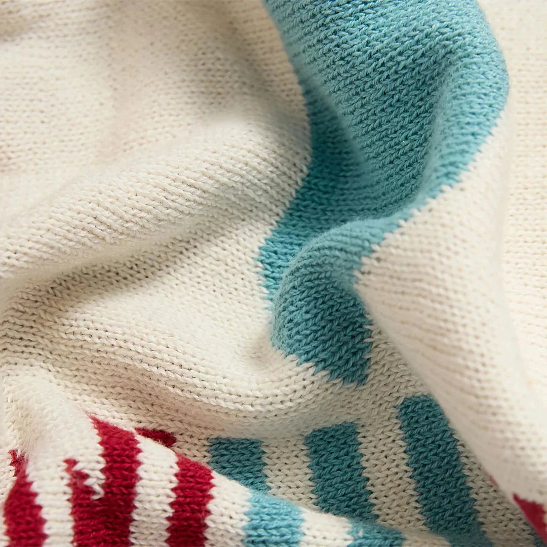 Cosy bohemian-style cotton blanket with vibrant geometric pattern, suitable for indoor and outdoor use