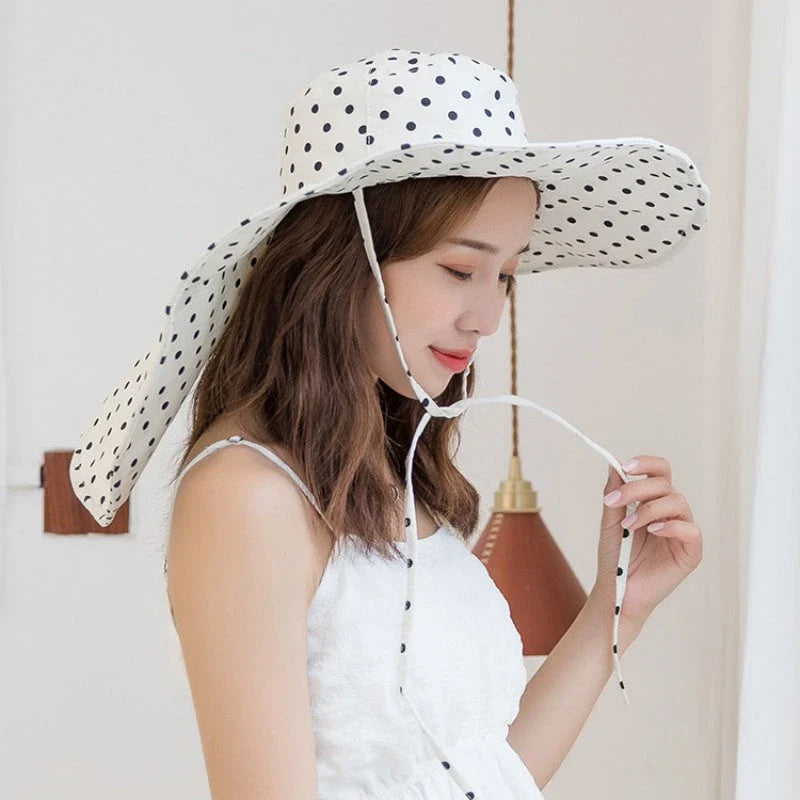 Elegant oversized polka dot sun hat for stylish UK women, offering excellent sun protection and a classic, fashionable design.