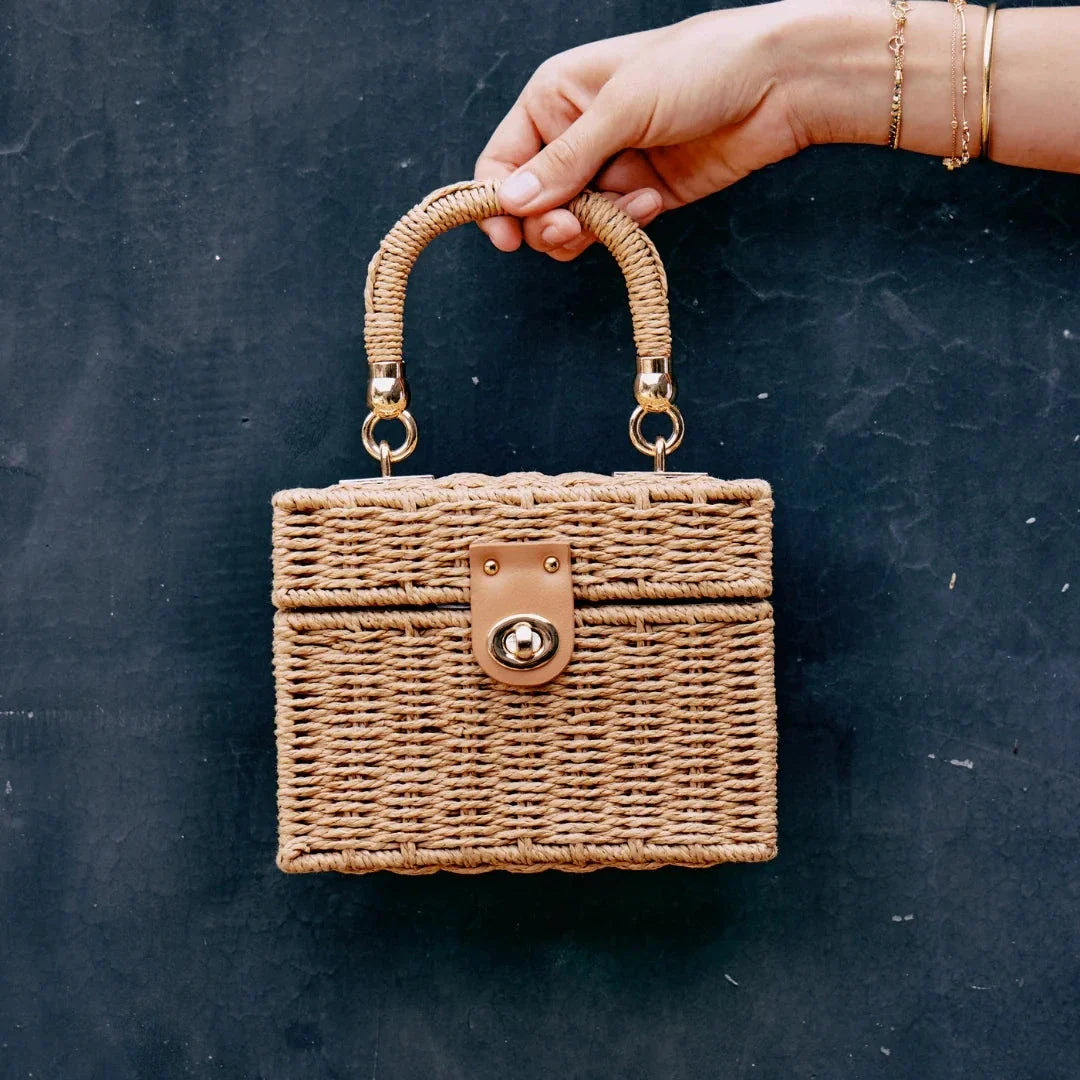 Handcrafted natural straw beach bag with bohemian-inspired design and detachable metal chain strap