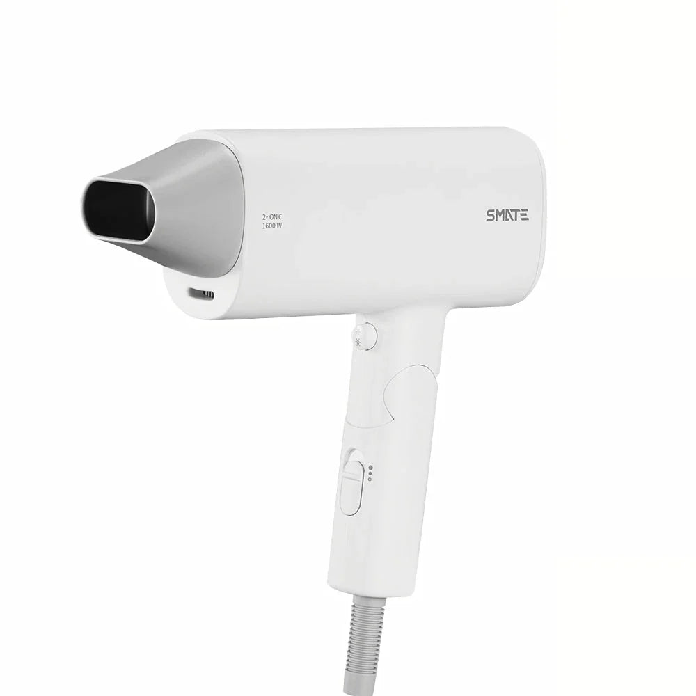 Compact and portable hair dryer with foldable handle, two-speed settings, and multiple nozzle positions for versatile styling