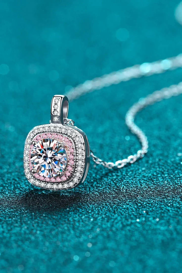 A rhodium-plated sterling silver necklace with a geometric pendant featuring a sparkling Moissanite gemstone over 0.3 carats.