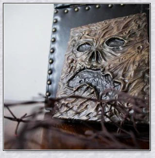 A haunting Necronomicon book with an embossed monster cover, aged pages, and a leathery, deathly texture