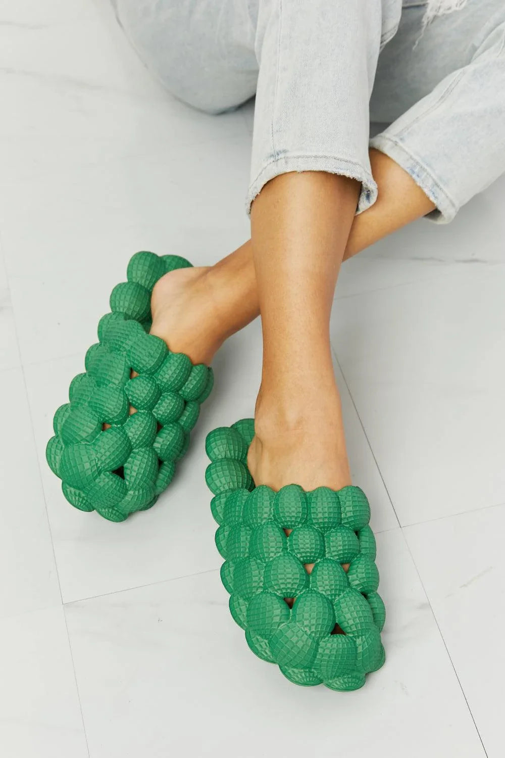Cosy green bubble slide slippers with plush cushioning and slip-on design