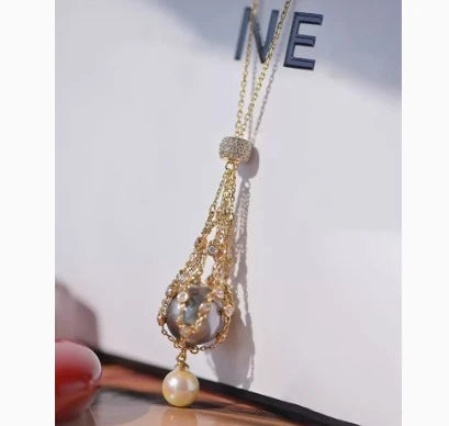 Elegant shell bead necklace with 18K gold plating and a delicate net crystal pendant
