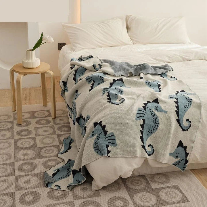 Cosy Sea Horse Cotton Throw Blanket in pink and lake blue colours, featuring a playful sea horse pattern and jacquard weave design.