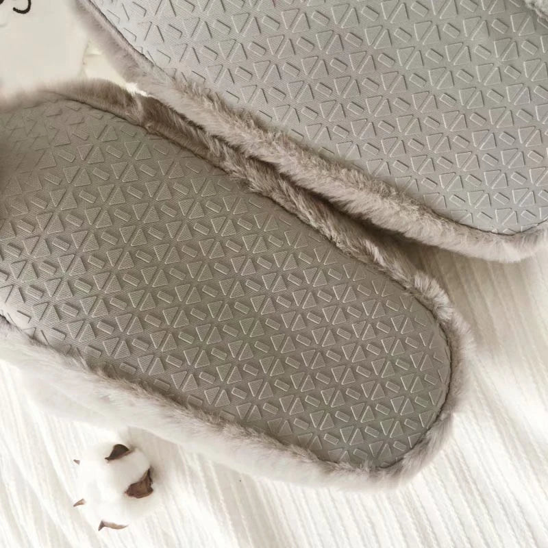 Pair of cosy, plush home slippers featuring a playful penguin design