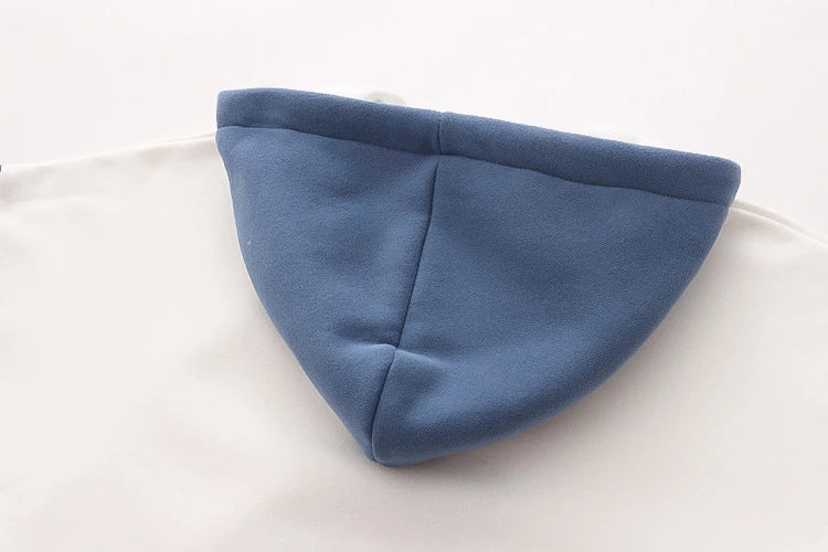A cosy, velvet-padded hooded sweater with playful alphabet sleeves in pink and blue colours