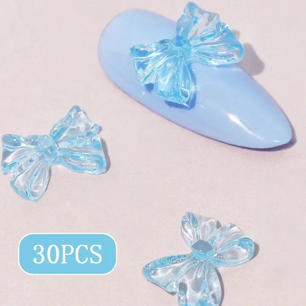 Charming candy-coloured bow nail charms in various colours, perfect for adding a playful touch to your manicure