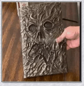 A haunting Necronomicon book with an embossed monster cover, aged pages, and a leathery, deathly texture