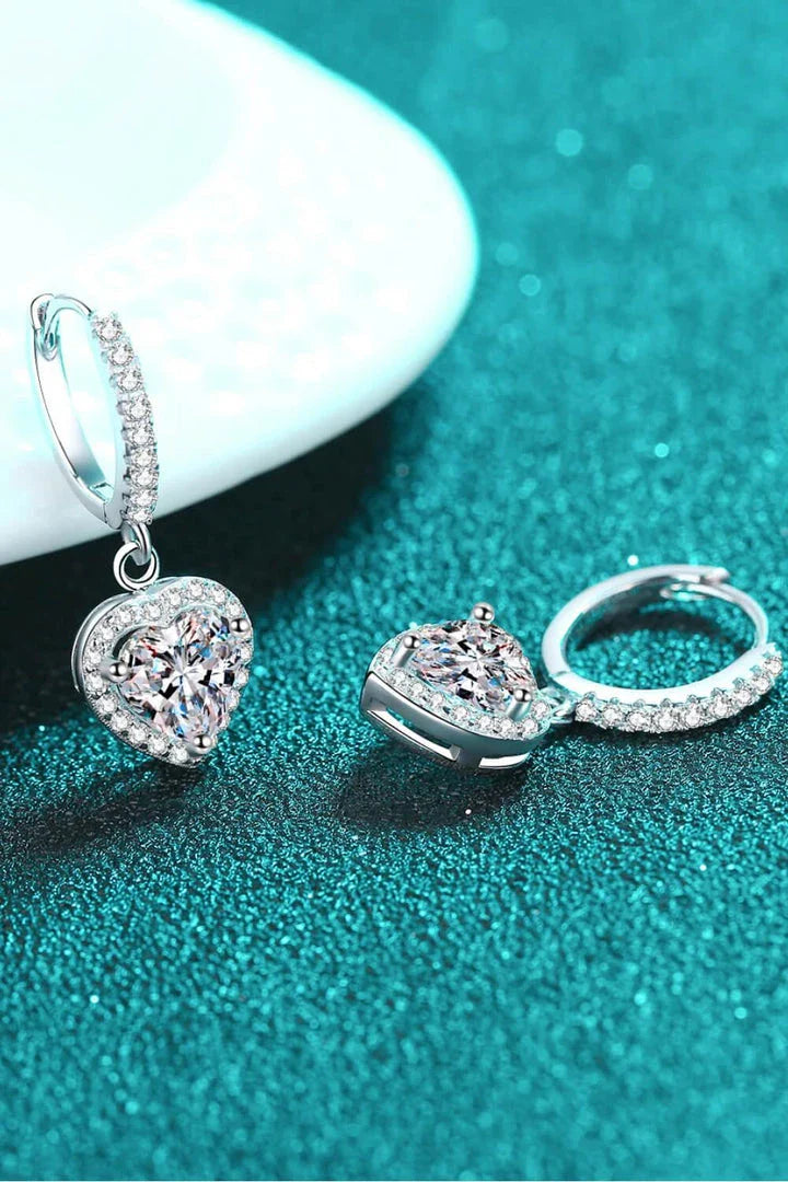 A pair of elegant moissanite heart-shaped drop earrings with a brilliant 2-carat display, crafted in 925 sterling silver with rhodium plating and zircon accents.