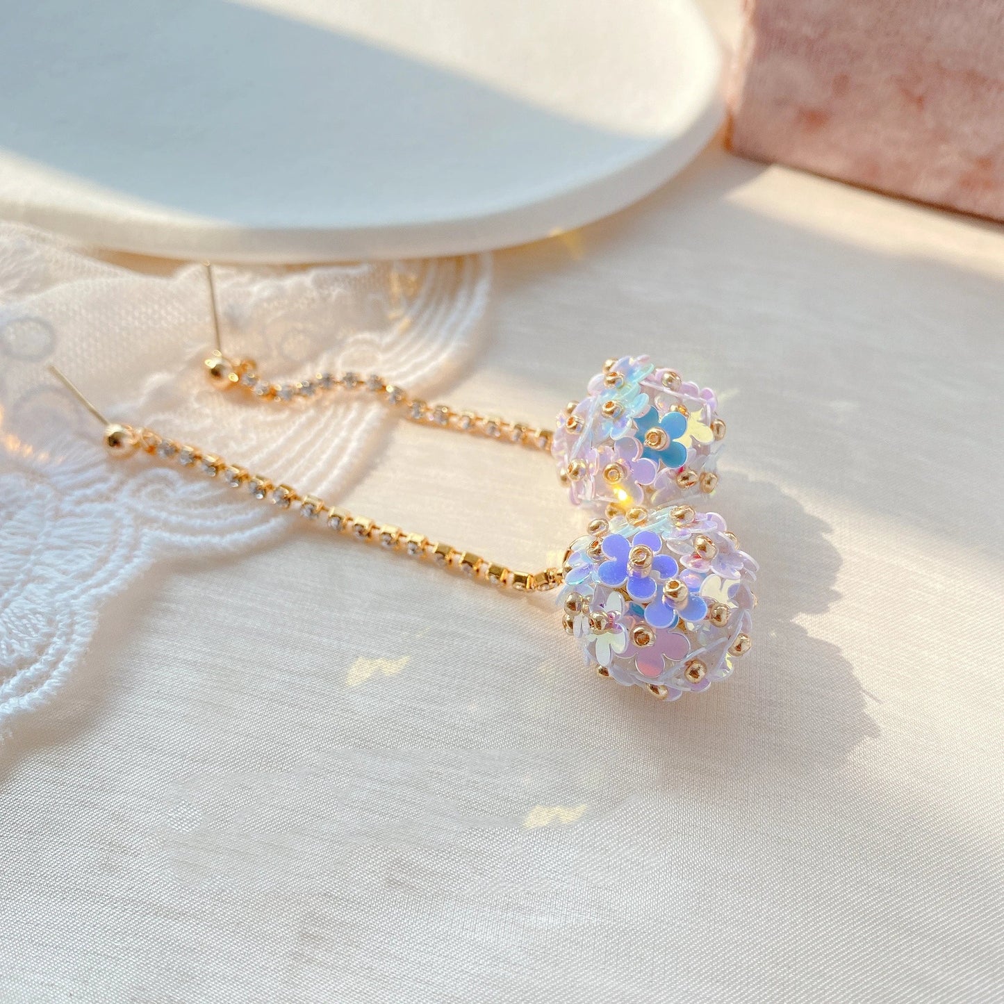 Elegant sterling silver floral drop earrings with delicate petal details, a timeless accessory for the modern British woman.