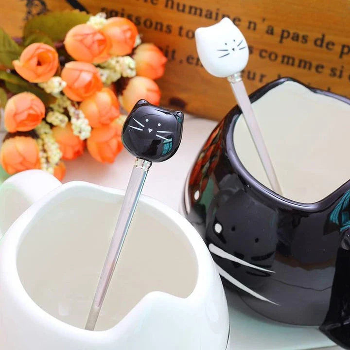 Charming black cat-shaped ceramic coffee mug with a spoon, a practical and whimsical addition to any coffee lover's collection