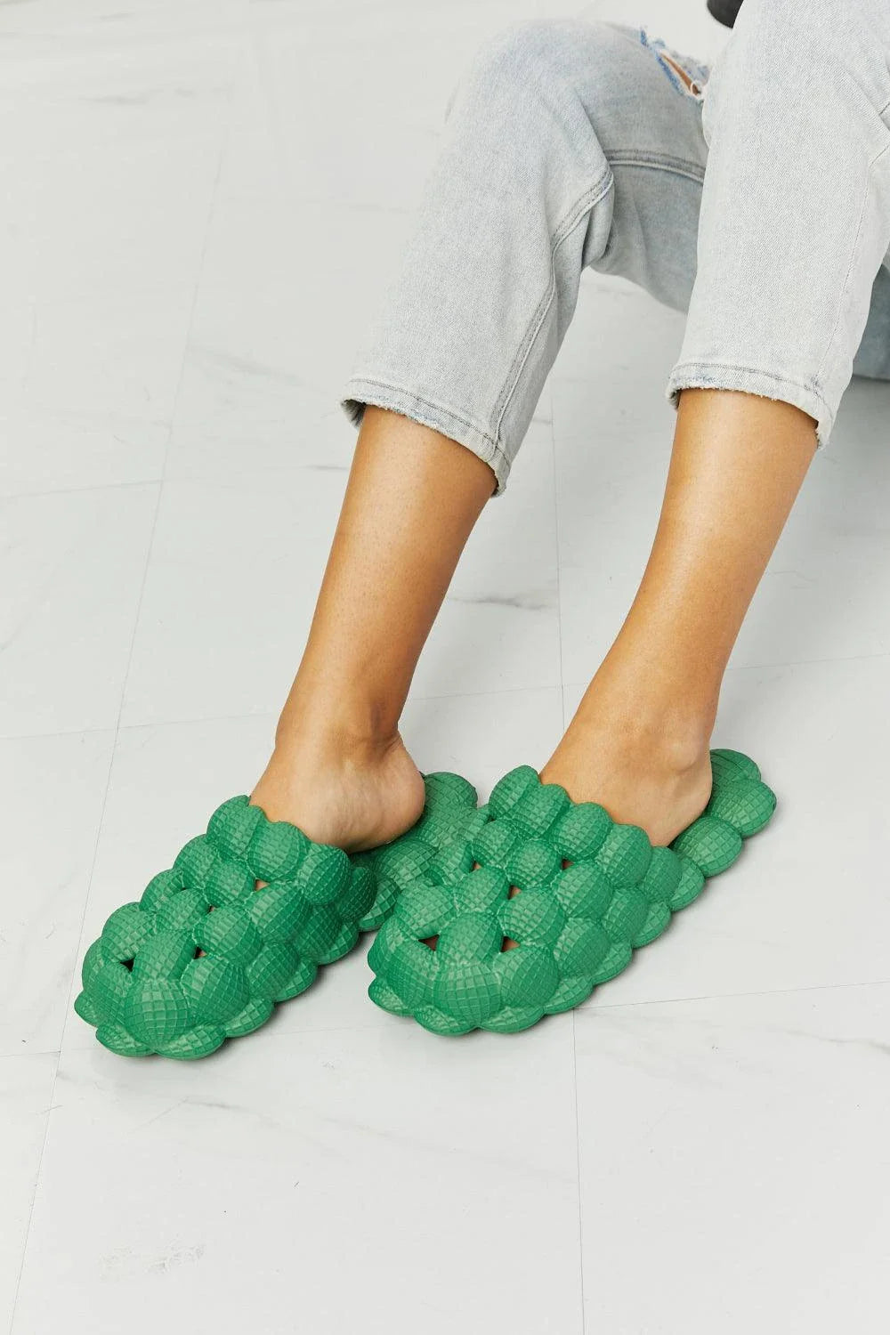 Cosy green bubble slide slippers with plush cushioning and slip-on design