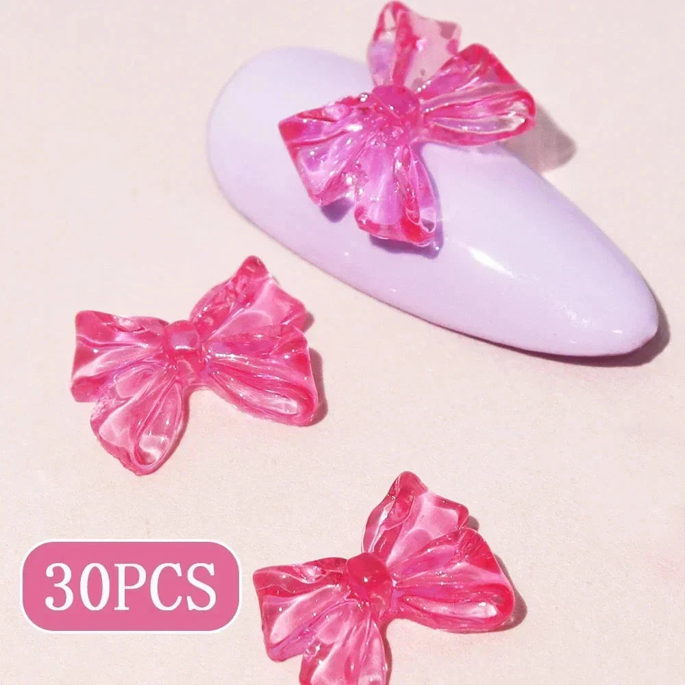 Charming candy-coloured bow nail charms in various colours, perfect for adding a playful touch to your manicure