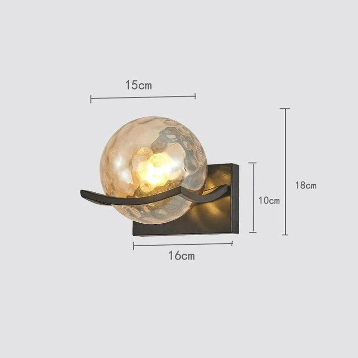 Modern black iron wall lamp with clear glass shade and LED lighting for a sophisticated look