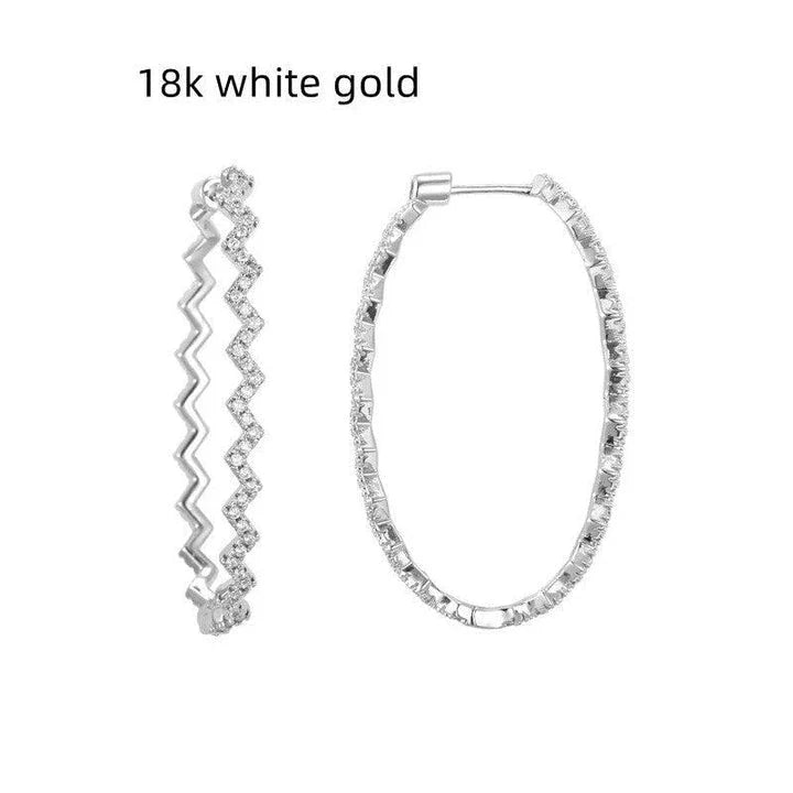 A pair of elegant sterling silver geometric earrings with a captivating wave-like pattern, inspired by the latest fashion trends in Japan and South Korea.