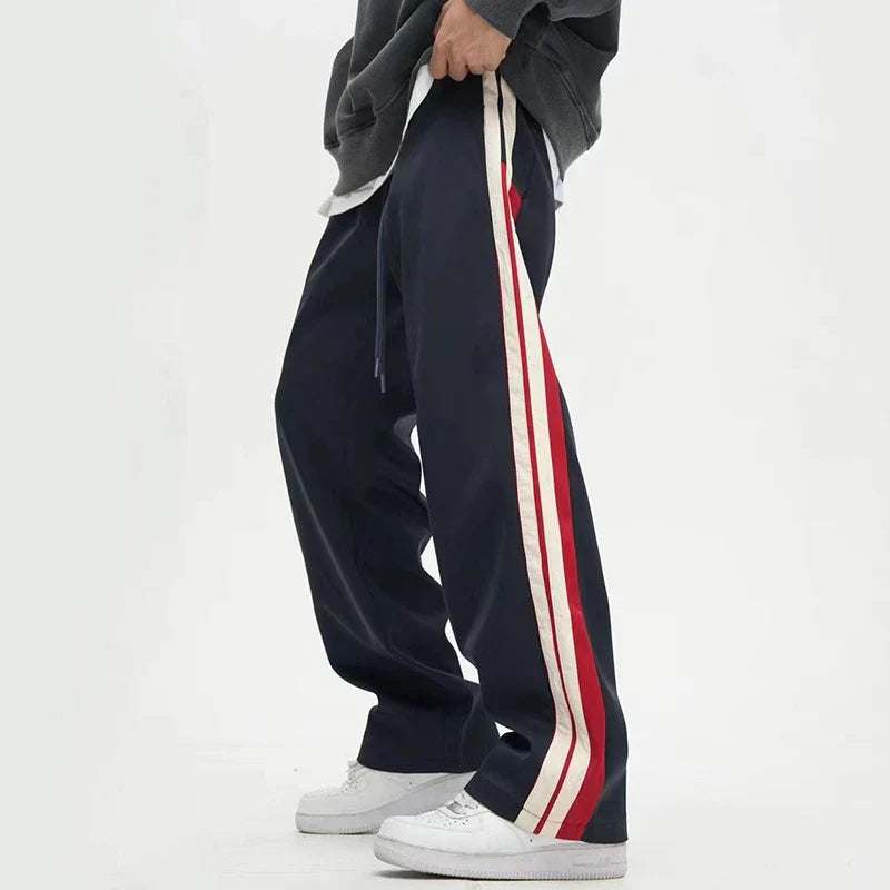 Chic wide-leg trousers in black and dark blue, featuring a draping silhouette and mid-waist design for a sophisticated look.