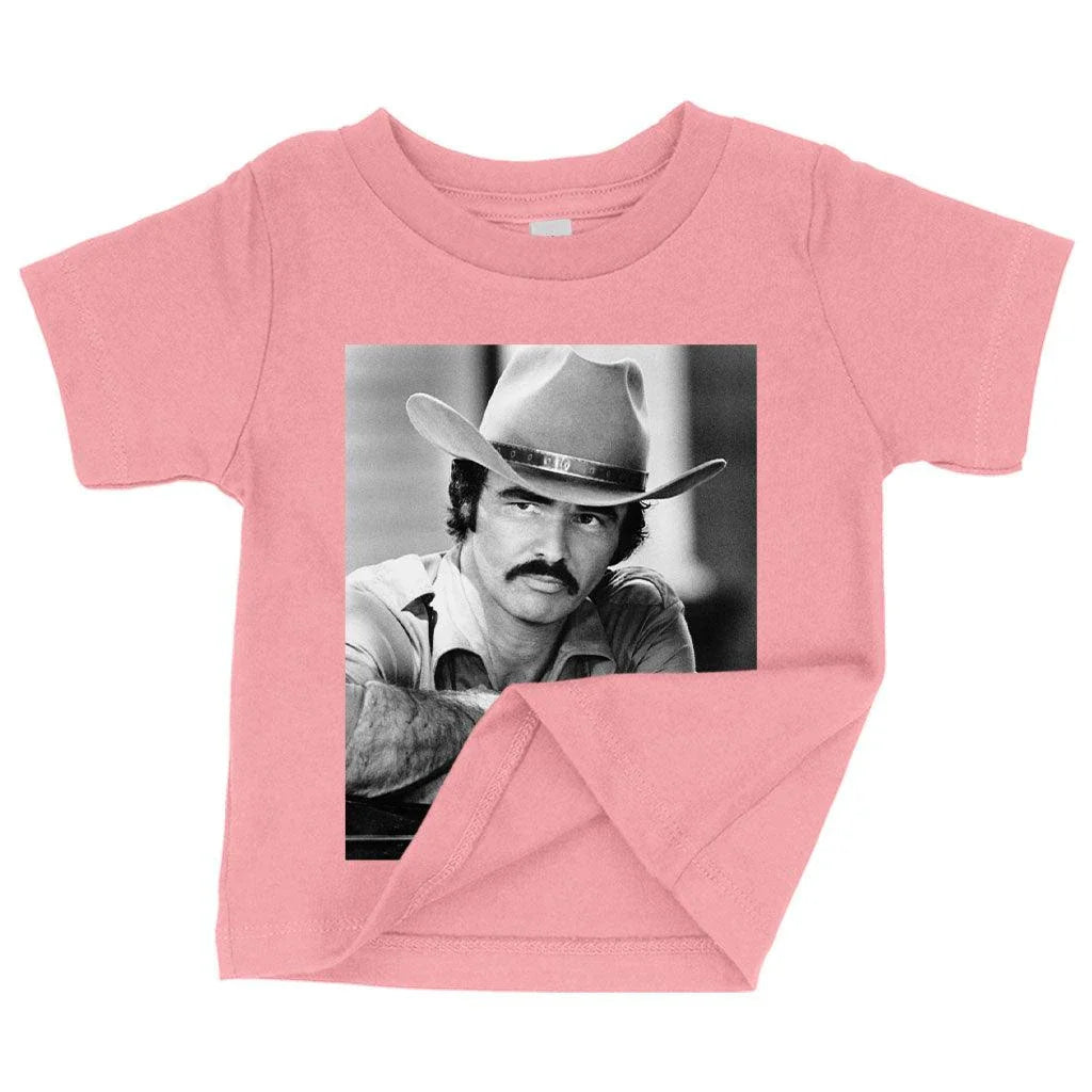 A vintage-inspired baby t-shirt featuring the iconic Burt Reynolds design, made with soft and breathable Airlume cotton.