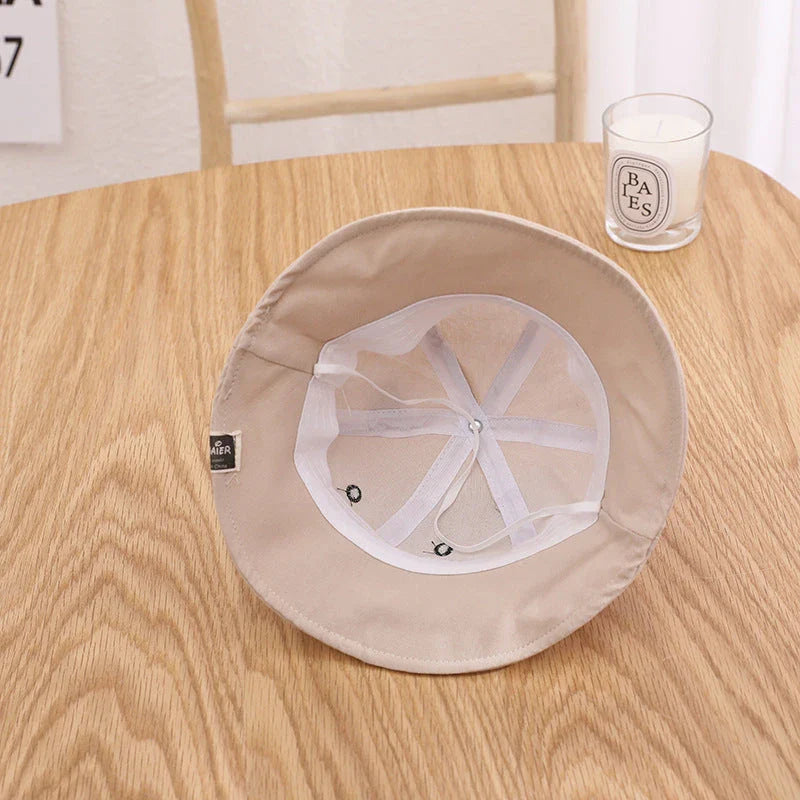 Adorable baby sun hat with cute bear ears, made of soft cotton and durable polyester for sun protection and comfort.