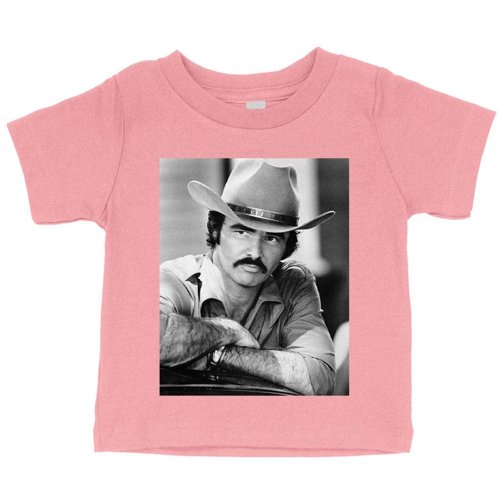 A vintage-inspired baby t-shirt featuring the iconic Burt Reynolds design, made with soft and breathable Airlume cotton.