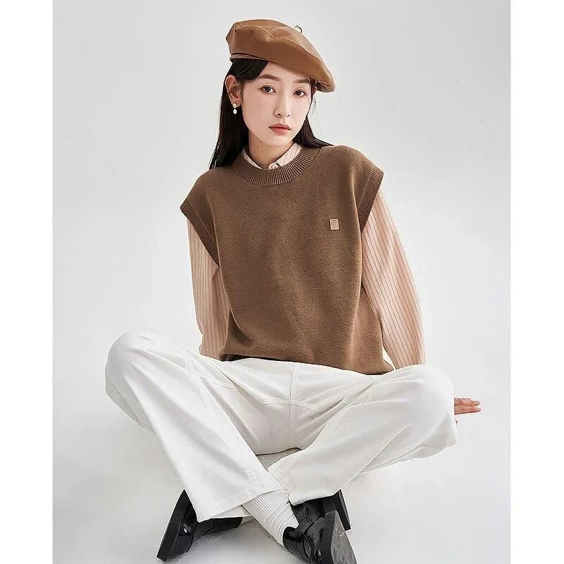 A cozy and chic knitted sleeveless vest in various colours, featuring a straight silhouette and a blend of premium materials for warmth and comfort.