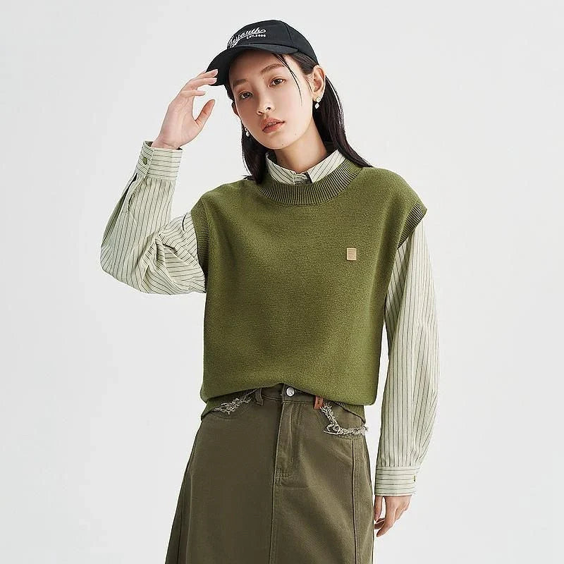 A cozy and chic knitted sleeveless vest in various colours, featuring a straight silhouette and a blend of premium materials for warmth and comfort.